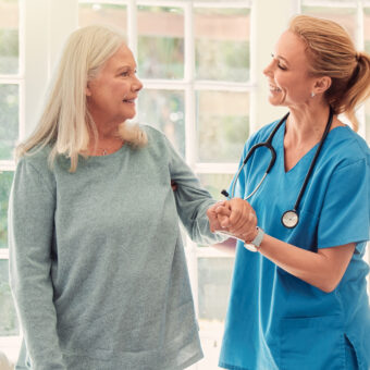 people appreciate and never forget that helping hand. shot of a senior woman being supported by her nurse at home.