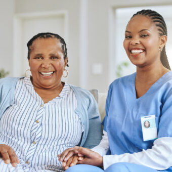 senior woman, nurse and holding hands portrait for support, healthcare and happiness at retirement home. elderly black person and caregiver together for trust, elderly care and help with homecare