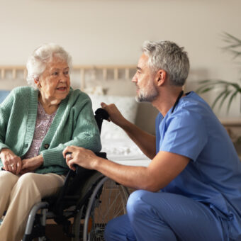 caregiver doing regular check up of senior woman in her home.