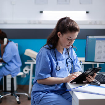 nurse checking appointments on tablet
